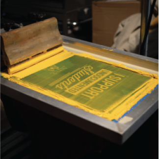 Screen printing frame with yellow ink on press